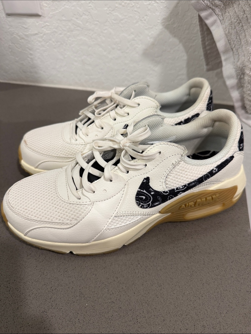 Nike Womenโs White Sneakers with Black Paisley Swoosh and Gum Sole